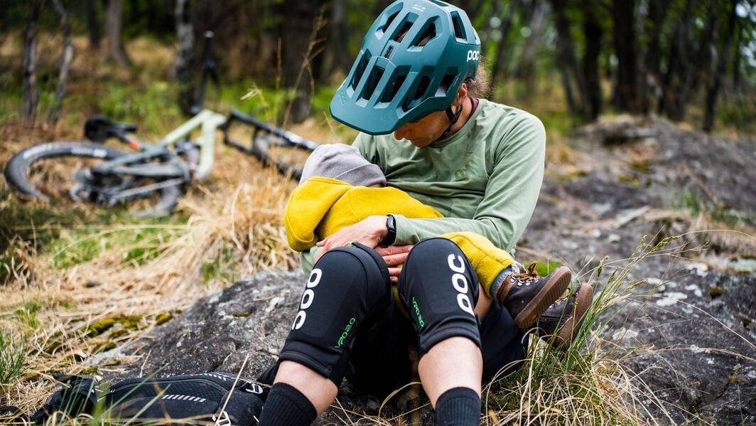 Ines Thoma sits on a rock slab to nurse her daughter Romy midway through a ride.