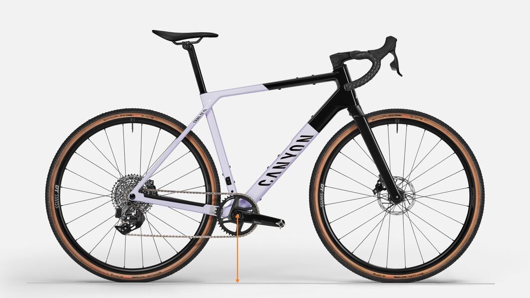Gravel Bike Bottom Bracket Height – Geometry for Stability and Clearance Side view of a Canyon gravel bike with bottom bracket height indicated, showing how this measurement affects ground clearance and ride handling.